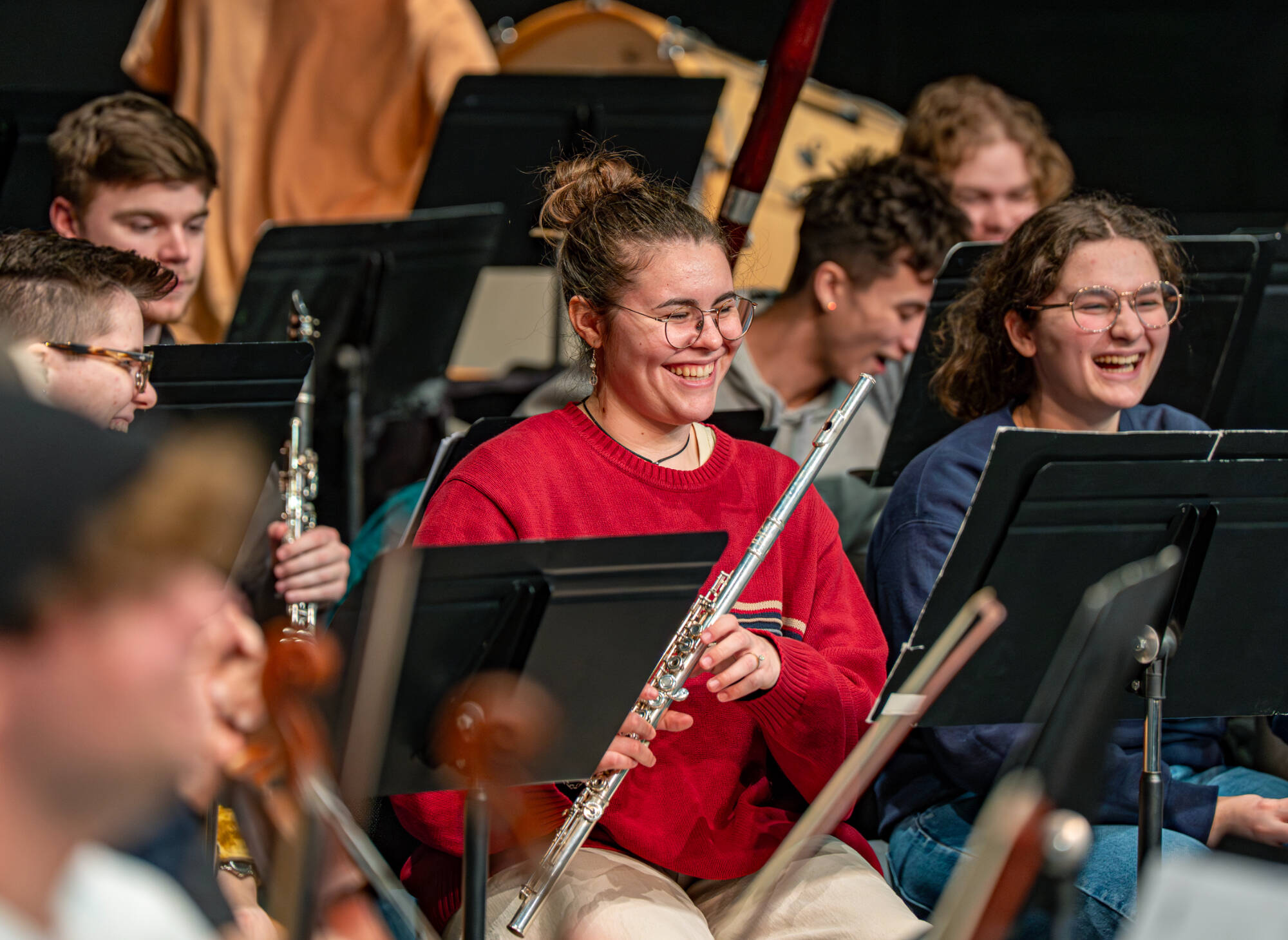 Flutist Grace Morrison (center) and oboist Elisa Skinner react during a rehearsal of Dr. Joel Schut’s MUS 103 Grand Valley Symphony Orchestra at the Louis Armstrong Theatre on February 23.